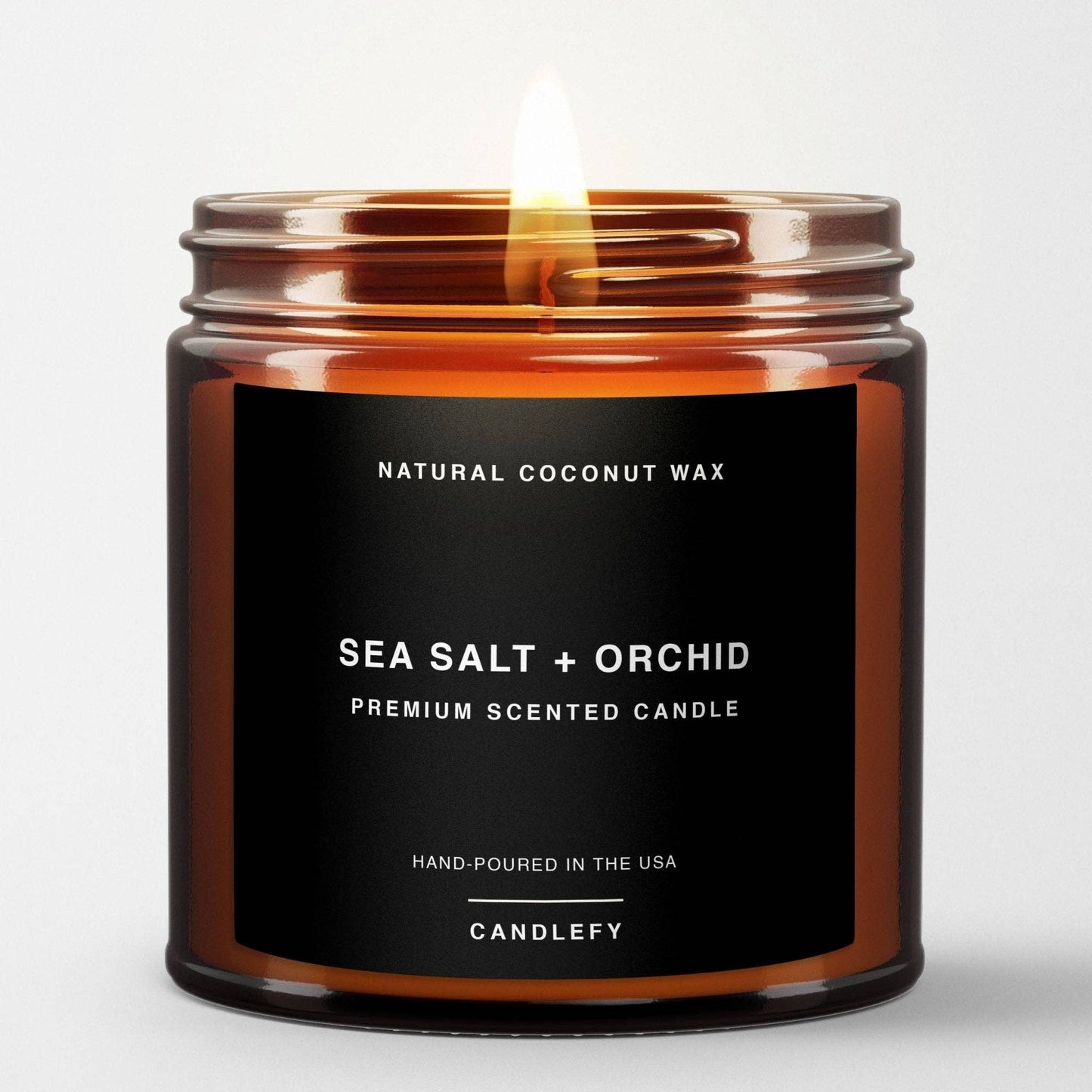 Sea Salt + Orchid scented candle in amber glass jar with natural coconut wax