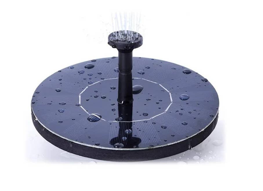 Solar powered fountain disc with water spray, 4 sprinkle heads, and stabilizers, operates without batteries or electricity in direct sunlight.
