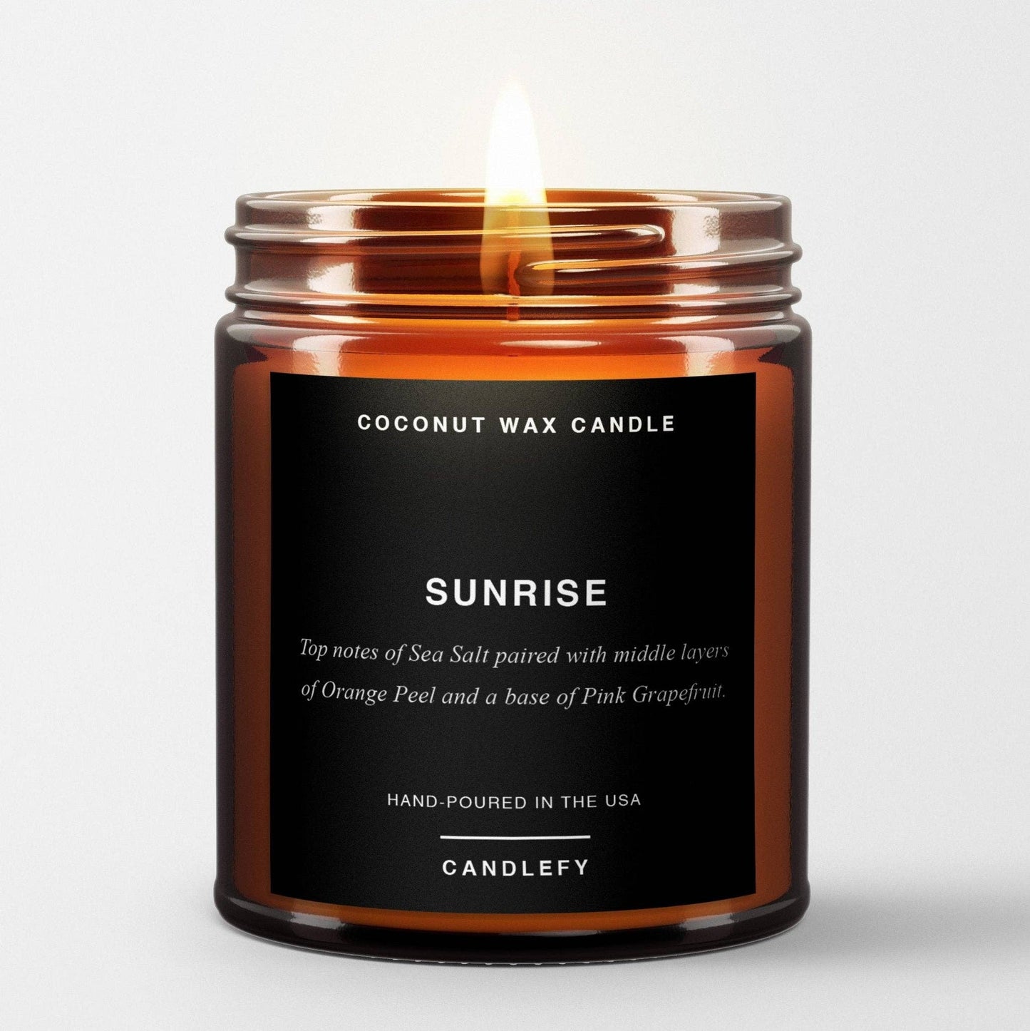 Sunrise scented candle in amber glass jar with fig and oceanic salt fragrance