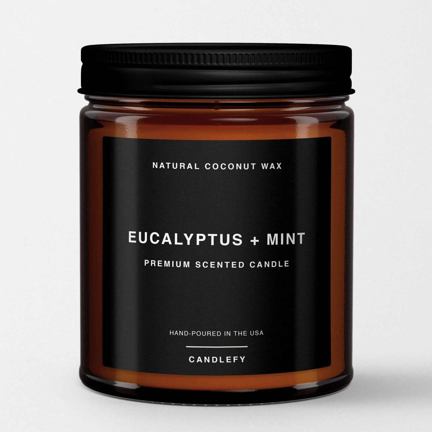 Amber glass jar candle with eucalyptus and mint scent made from natural coconut wax